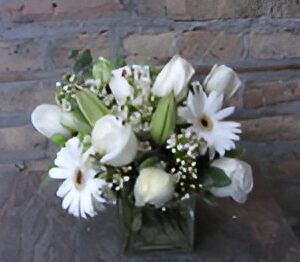 White floral arrangement in a glass vase.