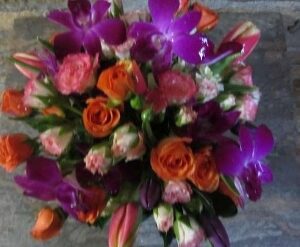 Colorful bouquet of roses and purple flowers.